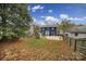 House and large backyard with plenty of fall leaves at 6934 Spring Morning Ln, Charlotte, NC 28227