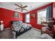 Charming bedroom with red walls, a king-size bed, and ample natural light at 6934 Spring Morning Ln, Charlotte, NC 28227