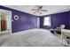 Spacious bedroom with purple walls, ceiling fan, and plush carpeting at 6934 Spring Morning Ln, Charlotte, NC 28227