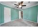 Teal bedroom with ceiling fan, closet, and access to upstairs hallway at 6934 Spring Morning Ln, Charlotte, NC 28227