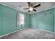Light teal bedroom with ceiling fan and playful monkey wall decals at 6934 Spring Morning Ln, Charlotte, NC 28227