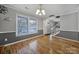 Light-filled dining area with hardwood floors and access to stairs at 6934 Spring Morning Ln, Charlotte, NC 28227
