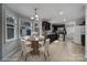 Virtually staged kitchen with dark cabinets and dining area at 6934 Spring Morning Ln, Charlotte, NC 28227