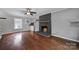 Living room with hardwood floors, fireplace, and window at 6934 Spring Morning Ln, Charlotte, NC 28227