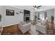 Virtually staged living room with fireplace and hardwood floors at 6934 Spring Morning Ln, Charlotte, NC 28227