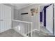 Upstairs hallway with grey walls and access to bedrooms at 6934 Spring Morning Ln, Charlotte, NC 28227