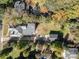An aerial shot of the property shows a well-maintained home, detached garage, and mature trees at 70 Spring Nw St, Concord, NC 28025