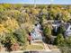 Aerial view showcasing a beautiful home with mature trees, a detached garage, and neighborhood charm at 70 Spring Nw St, Concord, NC 28025