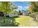 Expansive backyard featuring a detached garage, mature trees, and plenty of room for recreation at 70 Spring Nw St, Concord, NC 28025