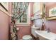 Charming bathroom featuring floral curtains and decorative mirror at 70 Spring Nw St, Concord, NC 28025