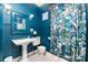 This bathroom has a pedestal sink and floral curtains at 70 Spring Nw St, Concord, NC 28025