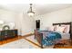 Bright bedroom features hardwood floors, ceiling light fixture and a dark wood dresser at 70 Spring Nw St, Concord, NC 28025
