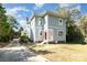 Charming two-story home boasts classic architecture, fresh blue siding, and a welcoming red front door at 70 Spring Nw St, Concord, NC 28025