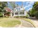 Charming two-story home featuring a welcoming front porch, beautiful landscaping, and classic architectural details at 70 Spring Nw St, Concord, NC 28025