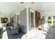 The inviting front porch features wicker furniture and brick accents at 70 Spring Nw St, Concord, NC 28025