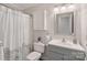 Clean bathroom with shower/tub combo, vanity, and linen cabinet at 12017 Baywoods Dr, Tega Cay, SC 29708