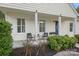 Inviting front porch with blue door and well-manicured landscaping at 12017 Baywoods Dr, Tega Cay, SC 29708