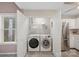 Convenient laundry closet with washer, dryer, and shelving at 12017 Baywoods Dr, Tega Cay, SC 29708