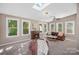 Sunroom with wood floors, fireplace, and multiple windows at 12017 Baywoods Dr, Tega Cay, SC 29708