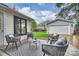 Cozy backyard patio area with seating and detached garage at 1915 Wedgedale Dr, Charlotte, NC 28210