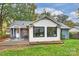 Home's back featuring a deck and patio furniture, surrounded by grass at 1915 Wedgedale Dr, Charlotte, NC 28210