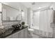 Clean bathroom, featuring a black vessel sink, white subway tile, and a shower/tub combo at 1915 Wedgedale Dr, Charlotte, NC 28210