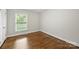 Bright bedroom with hardwood floors and large window at 1915 Wedgedale Dr, Charlotte, NC 28210