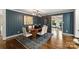 Elegant dining room with dark-blue walls, oval table, and hardwood floors at 1915 Wedgedale Dr, Charlotte, NC 28210