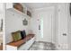 Modern entryway with built-in bench, storage, and patterned tile floor at 1915 Wedgedale Dr, Charlotte, NC 28210