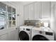 Bright laundry room, featuring white cabinets and LG washer and dryer at 1915 Wedgedale Dr, Charlotte, NC 28210