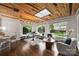 Sunroom features a skylight, built-in window seating, and wood ceiling at 1915 Wedgedale Dr, Charlotte, NC 28210