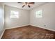 Simple bedroom with hardwood floors and two large windows at 316 Brawley Rd, Cleveland, NC 27013