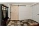 Inviting entryway with a stylish barn door, tiled floor, and built-in bench at 316 Brawley Rd, Cleveland, NC 27013