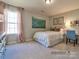 Bedroom with a double bed, desk, and light pink accents at 4540 Potters Wheel Dr, Fort Mill, SC 29715