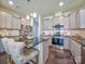 Modern kitchen with gray cabinets, granite countertops, and stainless steel appliances at 4540 Potters Wheel Dr, Fort Mill, SC 29715