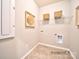 Bright laundry room with shelving and tile floor at 4540 Potters Wheel Dr, Fort Mill, SC 29715