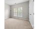 Well-lit bedroom with neutral walls, carpet, and window at 6941 Augustine Way, Charlotte, NC 28270