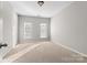 Bright bedroom with neutral walls and carpet, featuring two windows at 6941 Augustine Way, Charlotte, NC 28270