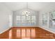 Bright dining room with hardwood floors and an arched window at 6941 Augustine Way, Charlotte, NC 28270