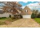 Two-story house with a large driveway and fall foliage at 6941 Augustine Way, Charlotte, NC 28270