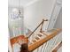 View of a staircase with hardwood steps and a chandelier above at 6941 Augustine Way, Charlotte, NC 28270