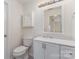 This bathroom features updated vanity, mirror, and toilet, providing a modern and functional space at 1101 E Morehead St # 32, Charlotte, NC 28204