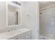 Bright bathroom features a large mirror, updated vanity, and shower over tub at 1101 E Morehead St # 32, Charlotte, NC 28204