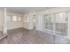 Bright living room featuring wood floors, big windows, and sliding glass doors to a private balcony at 1101 E Morehead St # 32, Charlotte, NC 28204