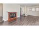 Spacious living room featuring hardwood floors and a cozy fireplace with traditional mantel at 1101 E Morehead St # 32, Charlotte, NC 28204