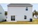 Back exterior of home showcasing the yard, siding, windows, and sliding glass doors at 159 Tanner Loop, Troutman, NC 28166