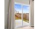 A view of the backyard and patio through a sliding glass door at 159 Tanner Loop, Troutman, NC 28166