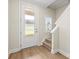 Bright entryway featuring a stairway, wood-look flooring, and a modern glass-paneled front door at 159 Tanner Loop, Troutman, NC 28166