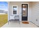 A welcoming foyer features natural light, a comfortable bench, and a stylish glass-paneled door at 159 Tanner Loop, Troutman, NC 28166