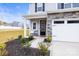 Inviting home entrance with a cozy bench, neat landscaping, and a welcoming front door at 159 Tanner Loop, Troutman, NC 28166